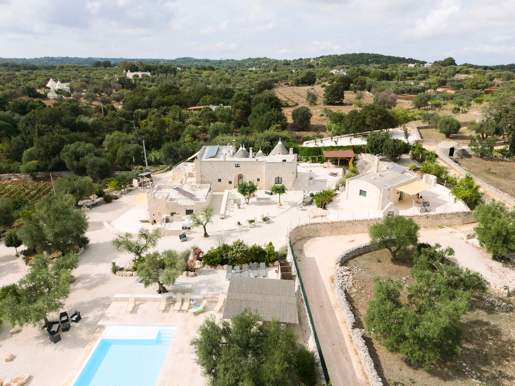 Aerial view of the trulli at Tenuta Semeraro among the olive groves of the Itria Valley