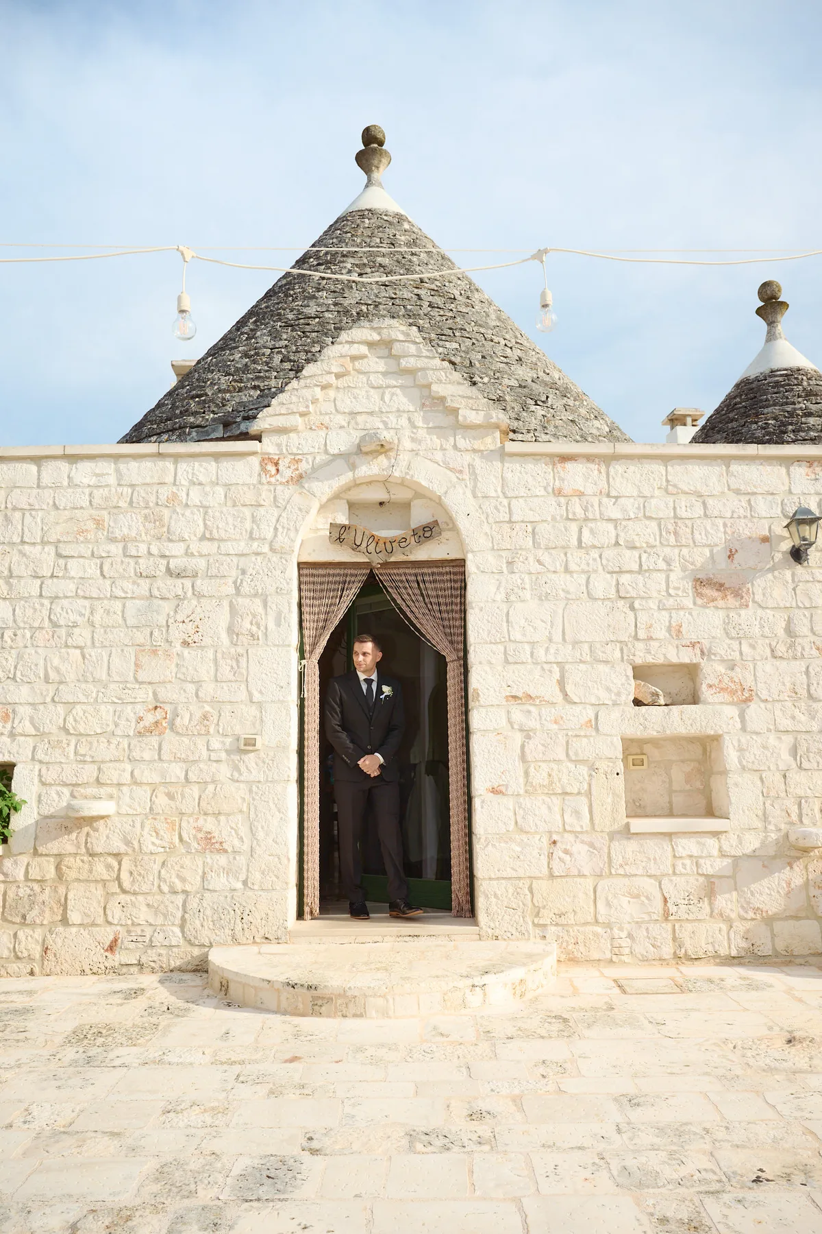 Brad waiting in the doorway of a trullo