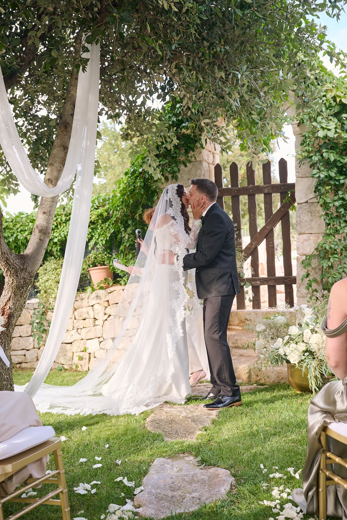 The first kiss as newlyweds under the white drapes