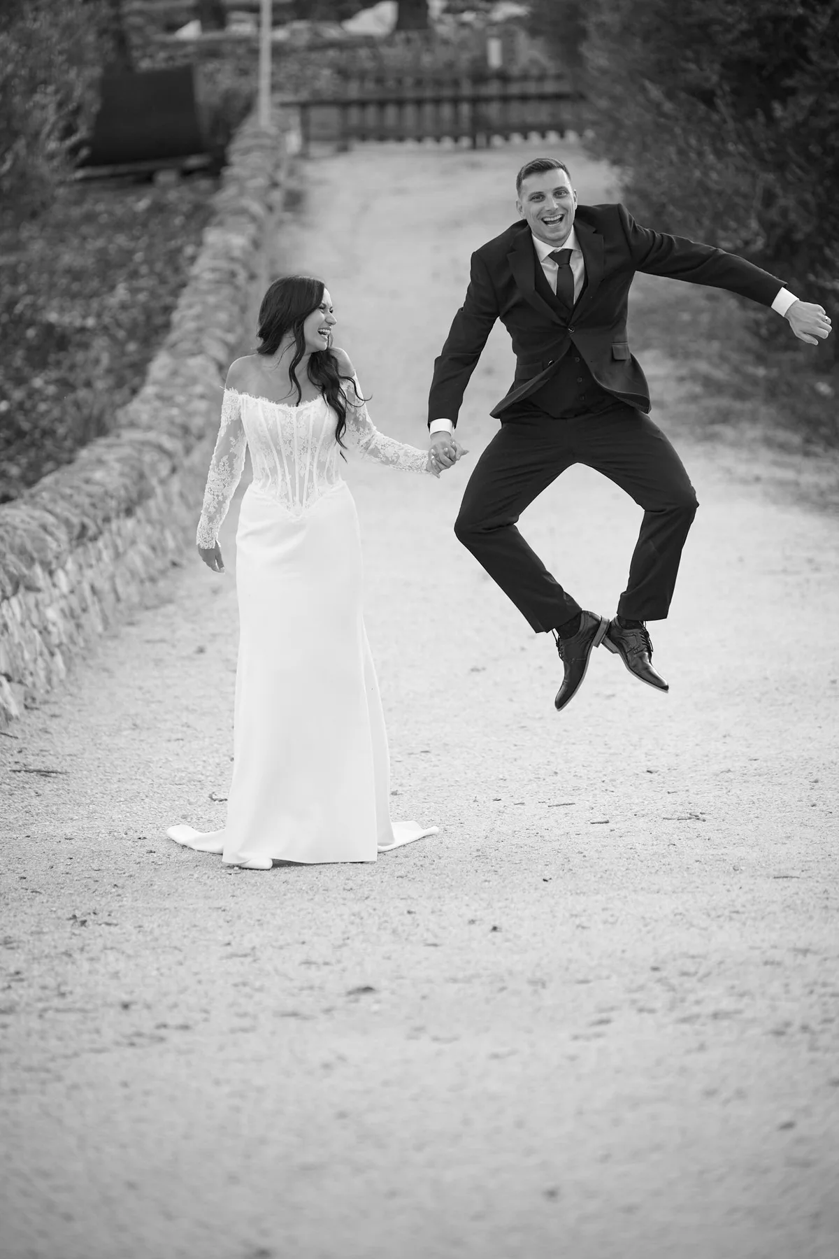Brad jumping for joy on the dirt path, in black and white