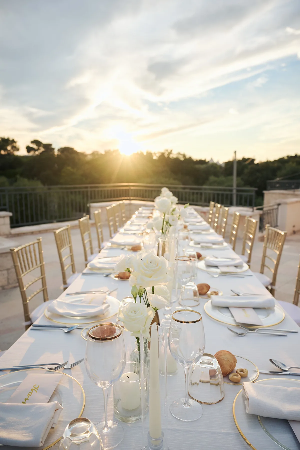 The long table set on the terrace at sunset