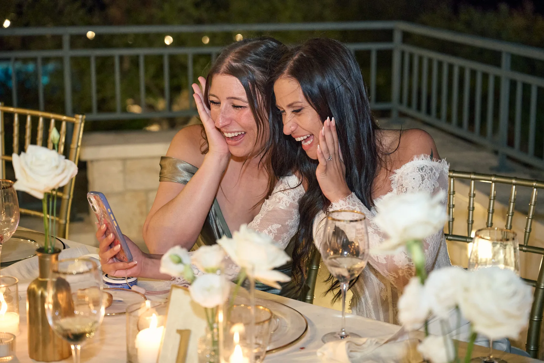 Jenny laughing with a friend during dinner