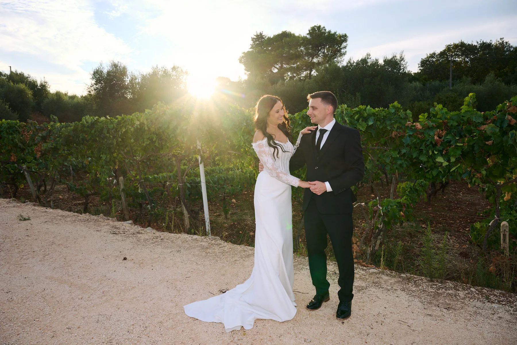 Jenny and Brad in the vineyard at Tenuta Semeraro with the setting sun behind them