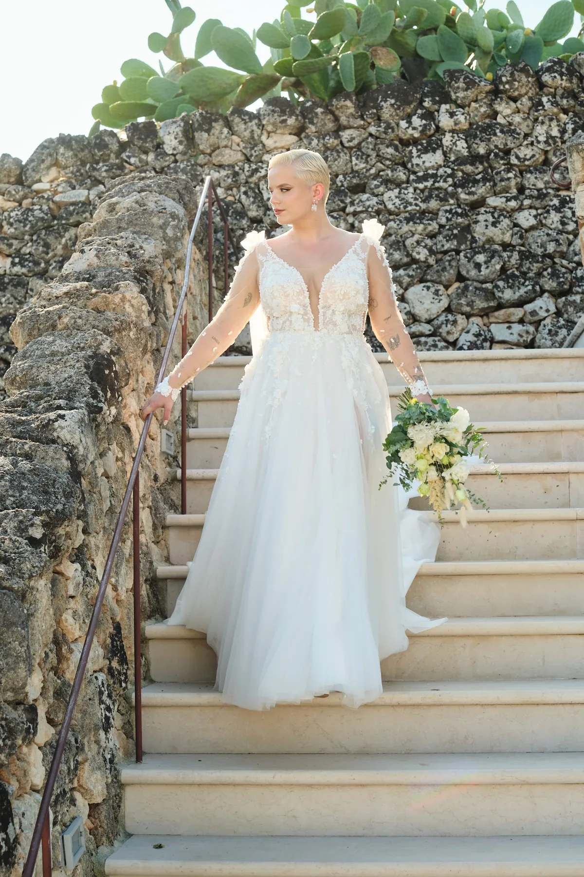 Natasha walking down the stone staircase between dry-stone walls