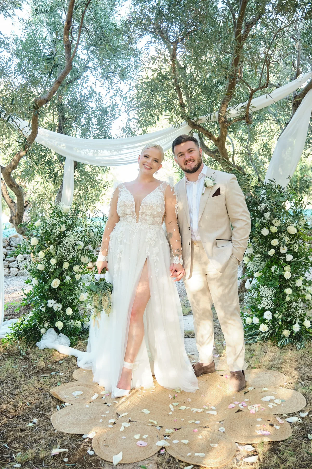 Natasha and Michael married under the floral arch