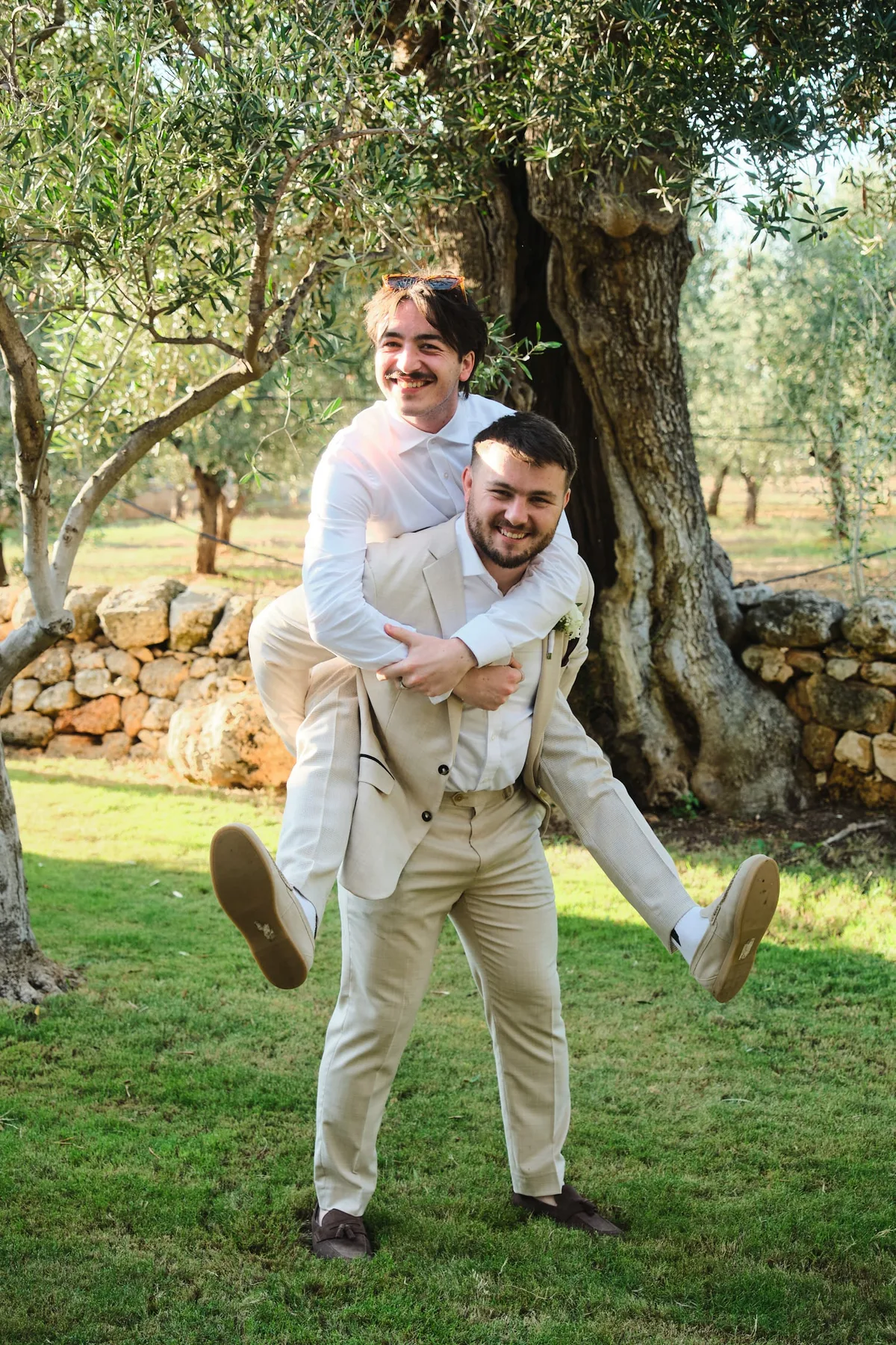 Michael giving a friend a piggyback among the olive trees