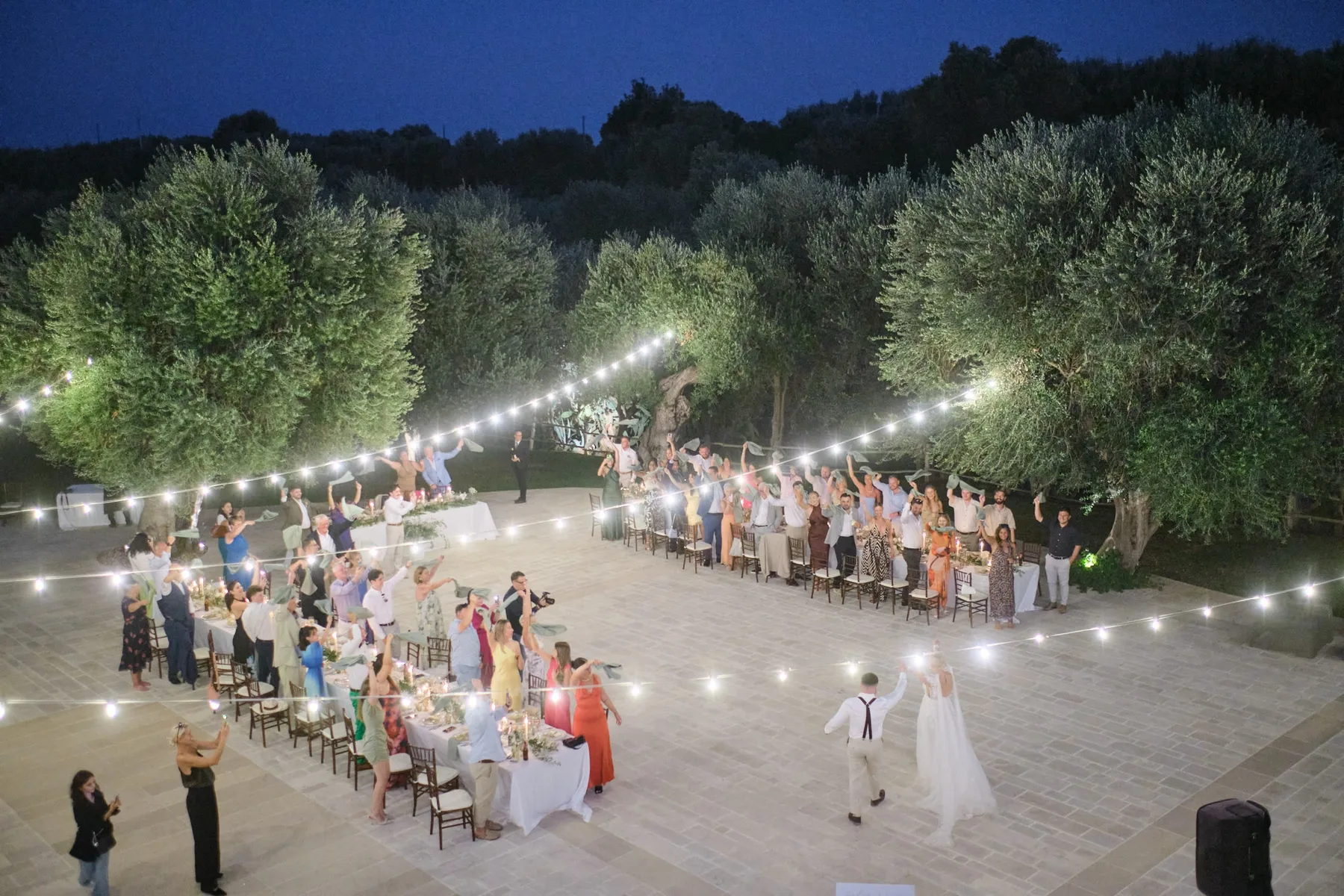 Dinner under the string lights seen from above