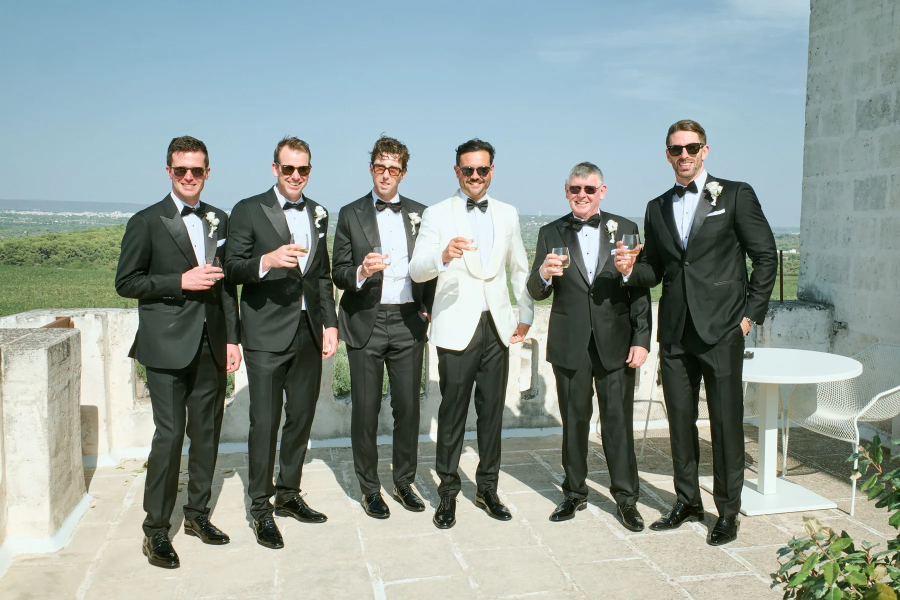The groom with his groomsmen on the terrace