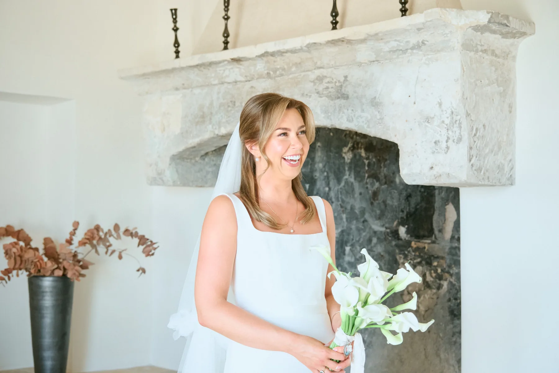 The bride ready beside the stone fireplace