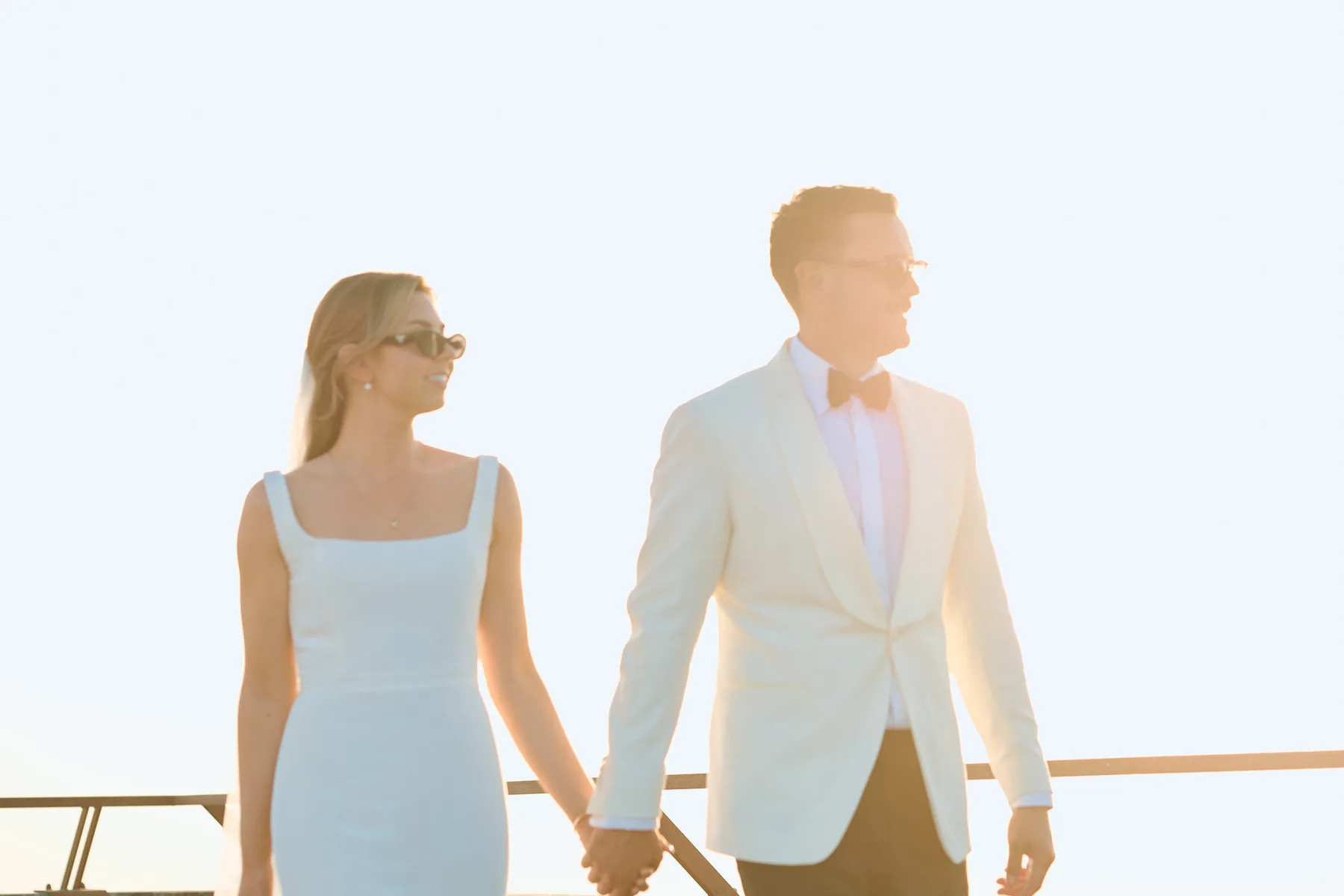 The couple hand in hand on the terrace