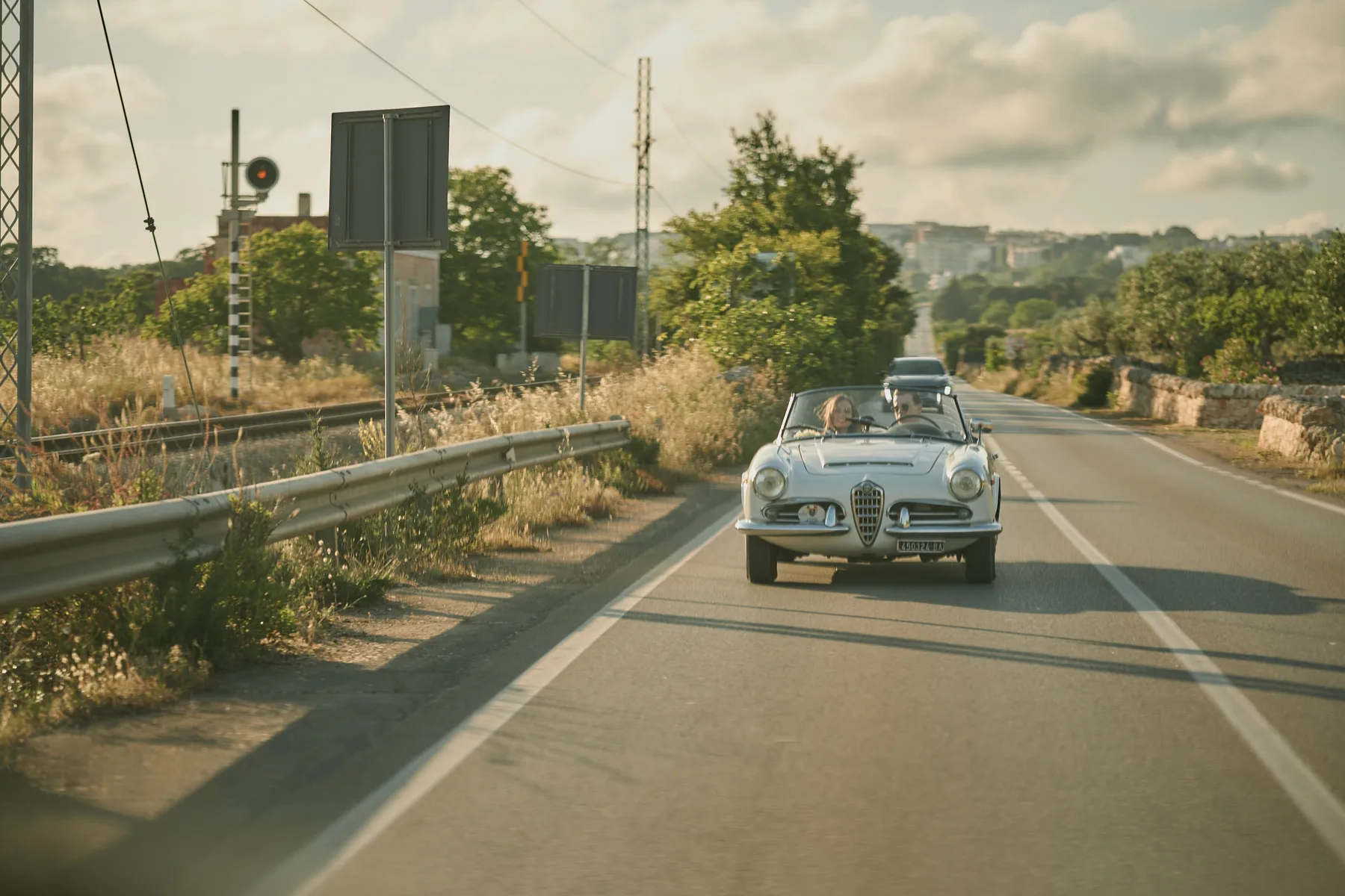 L’auto d’epoca degli sposi sulla strada di campagna