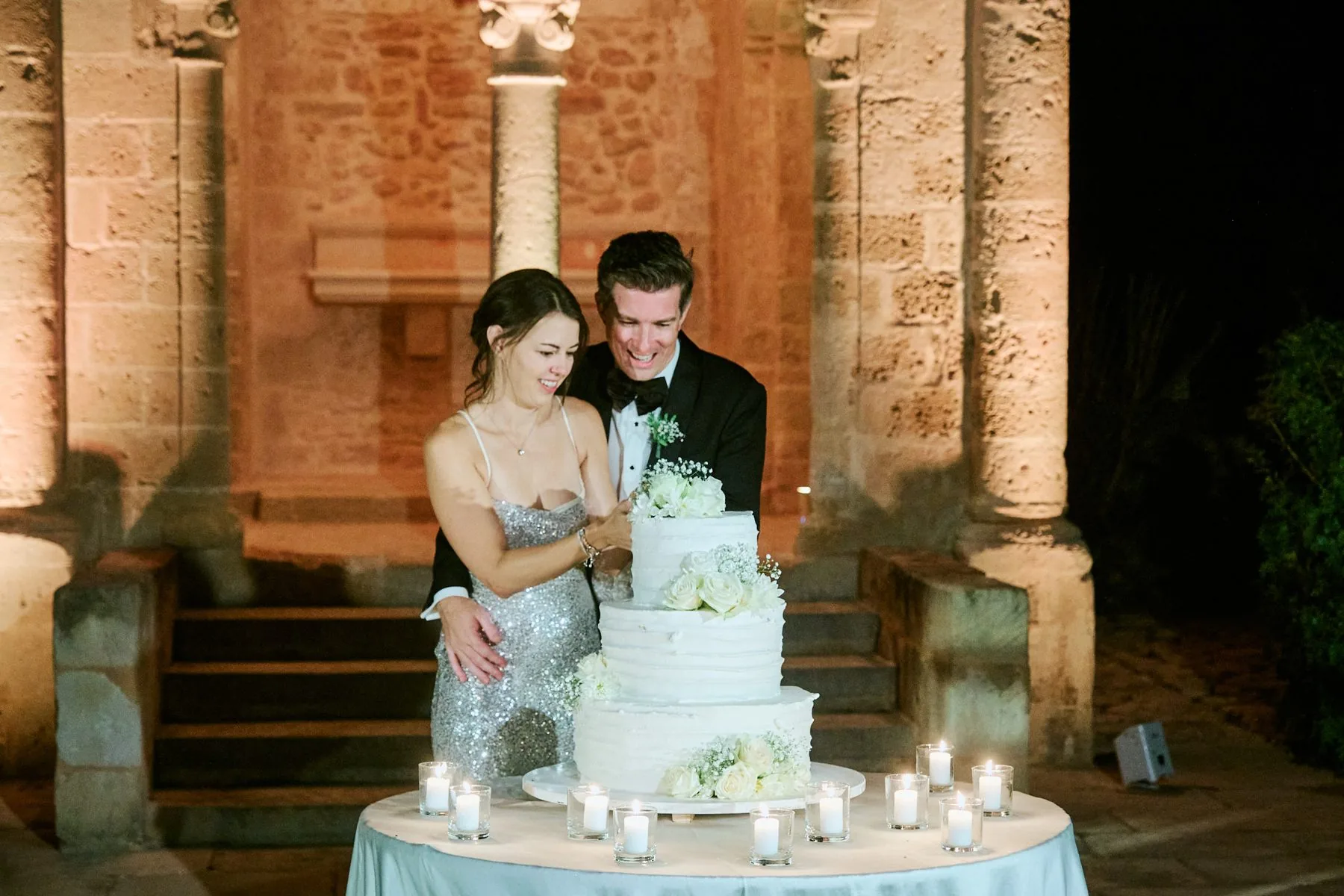 Katy and Gregory at the wedding cake table