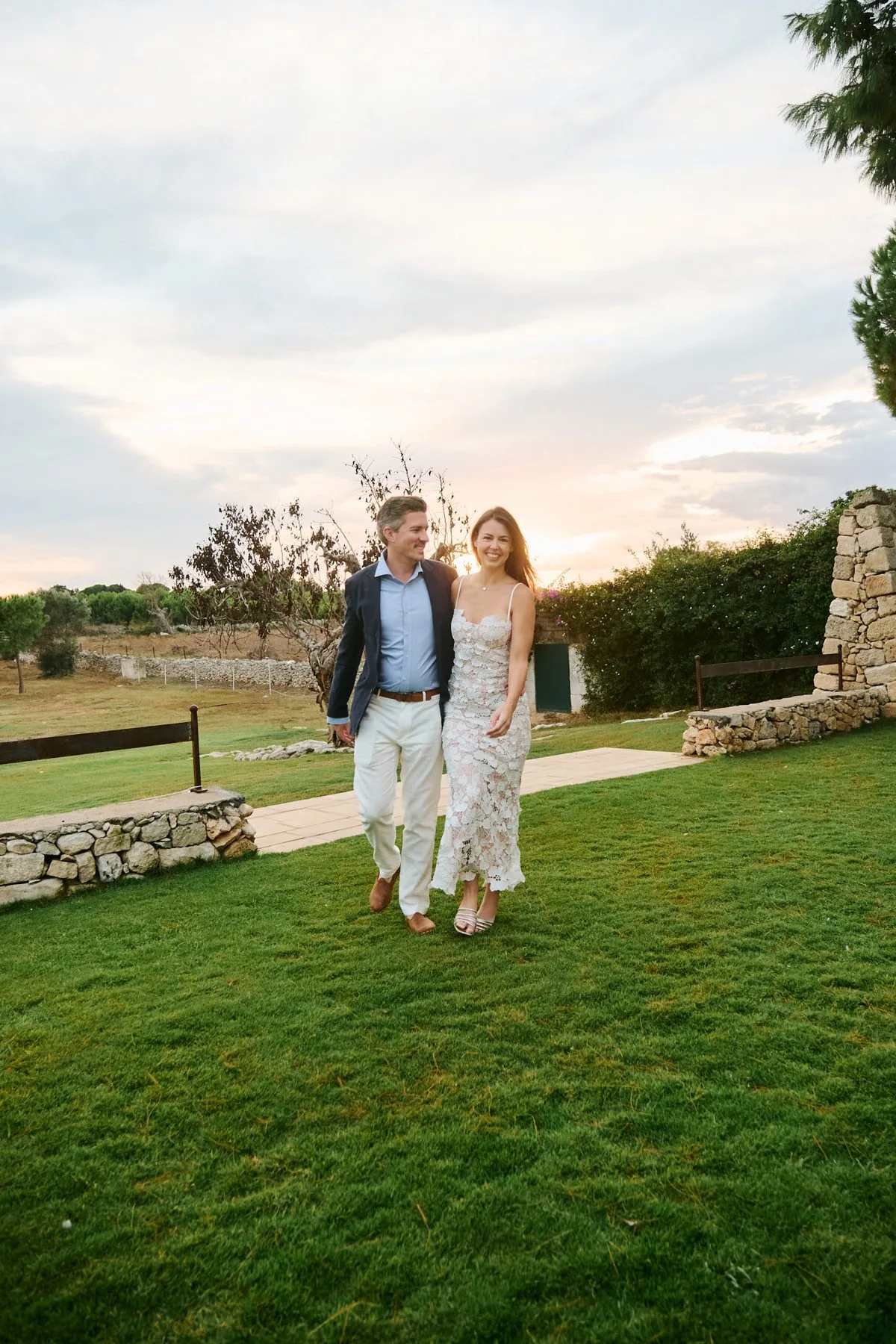 Katy and Gregory walking together through the golden countryside