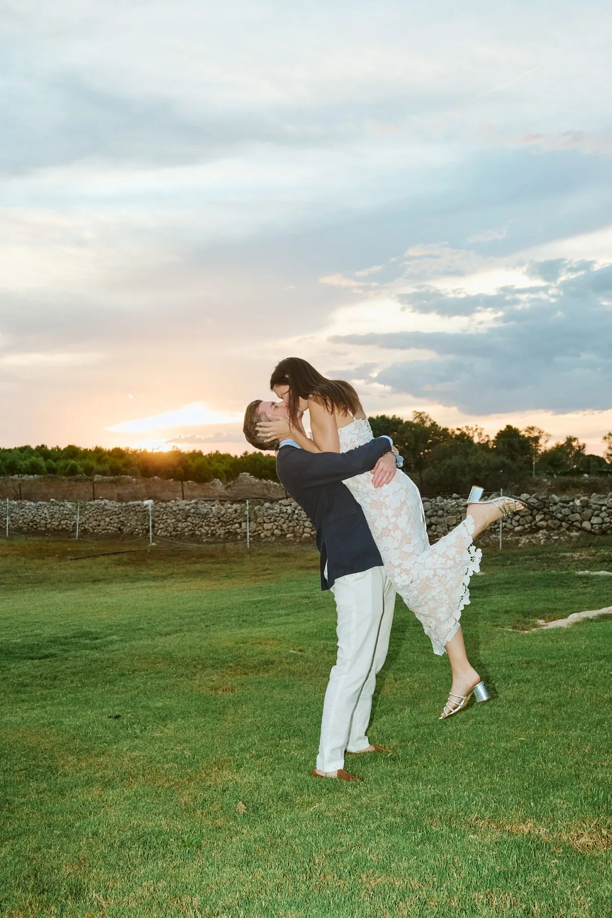 Gregory carrying Katy in his arms, both laughing