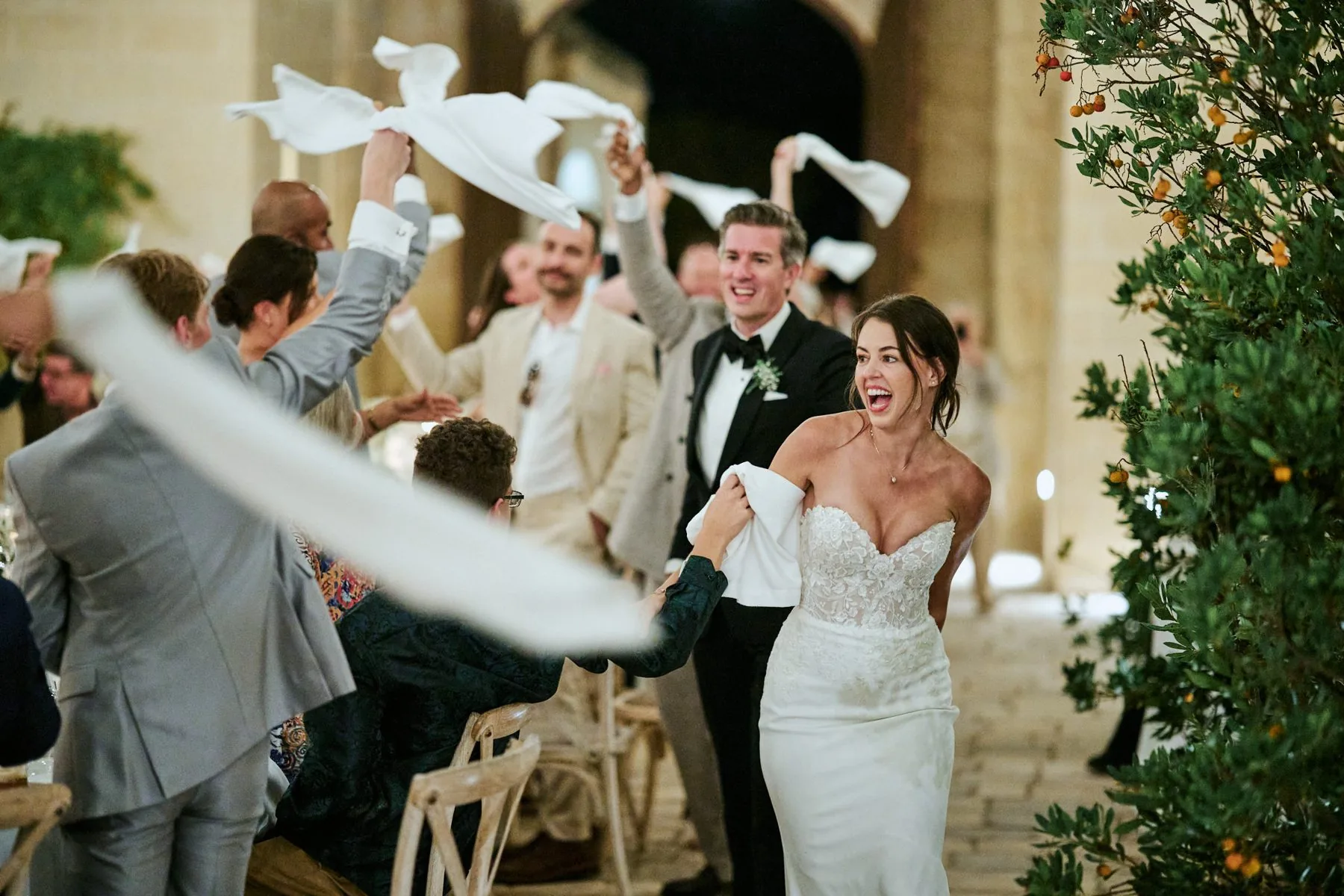 Guests cheering and waving white flags at the end of the ceremony
