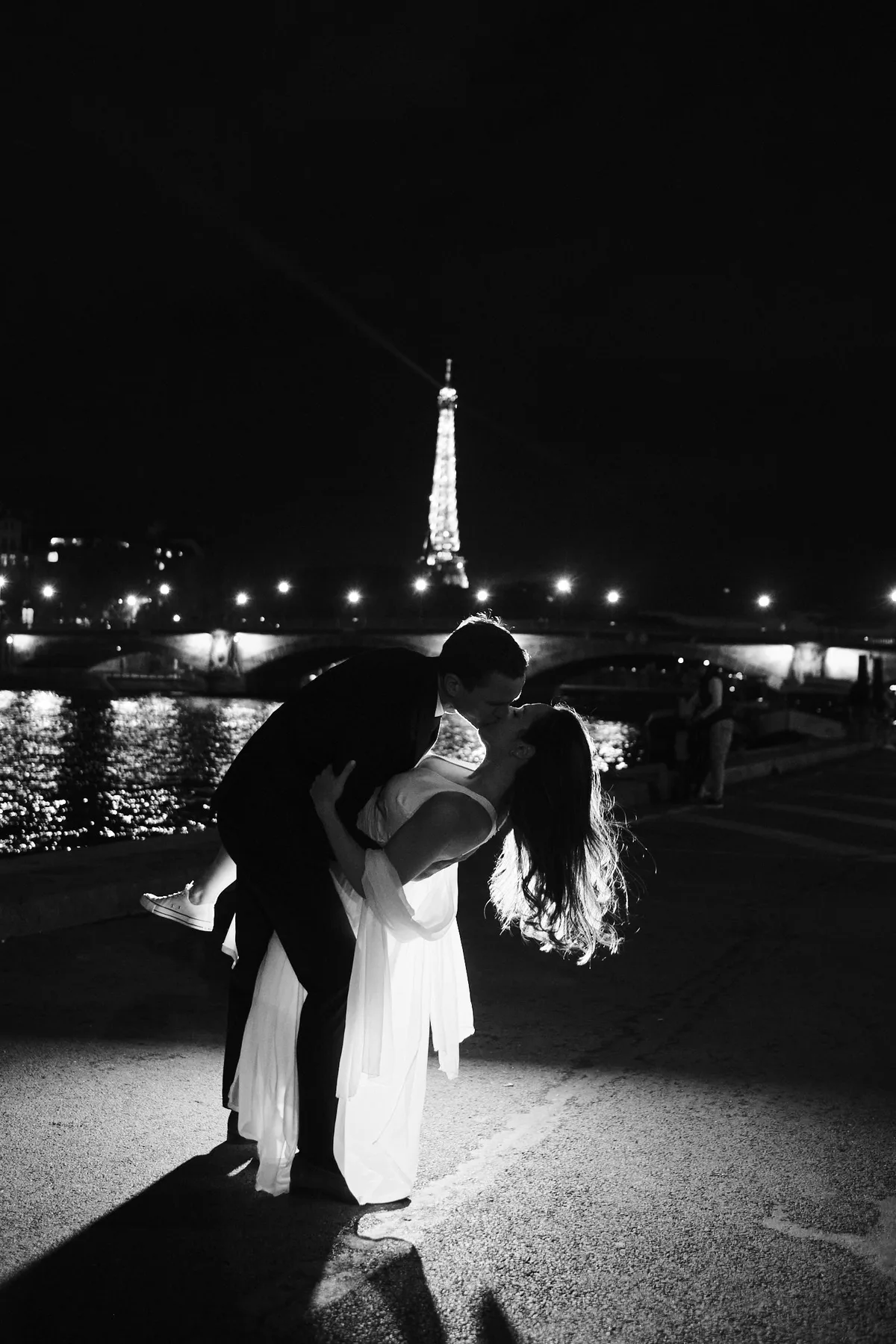 Il bacio con casqué sotto la Tour Eiffel che brilla